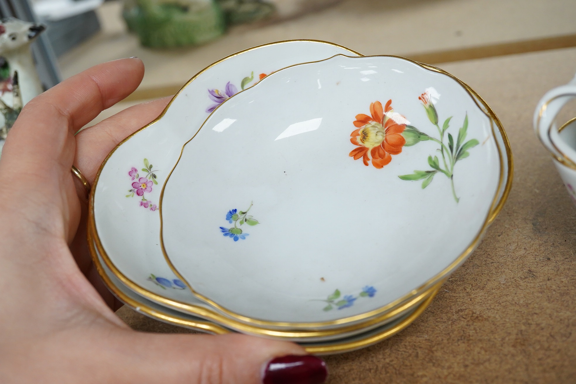 A group of 19th century Meissen porcelain cups and saucers. Condition - one teacup has a re-glued handle